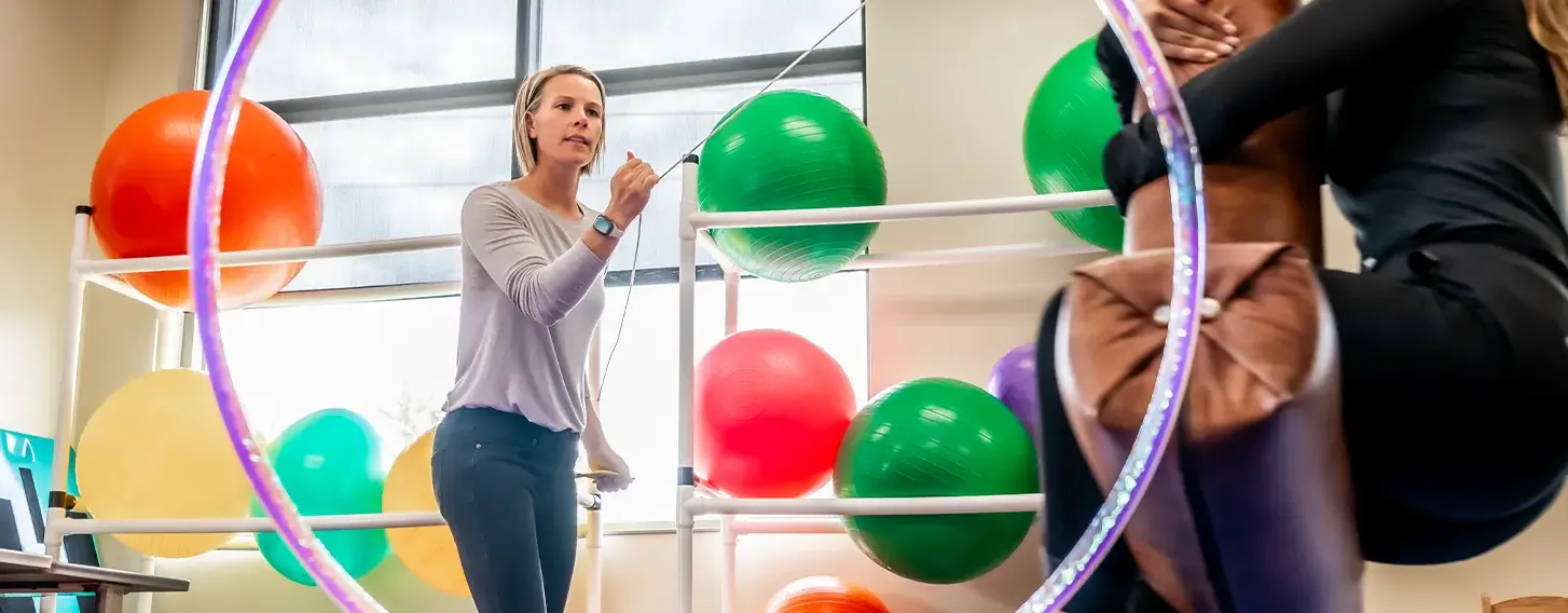 Professor leading sensory and motor skills lab in occupational therapy classroom.